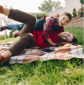 Mother and son lying on the lawn