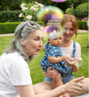 Family and baby enjoying a park lawn